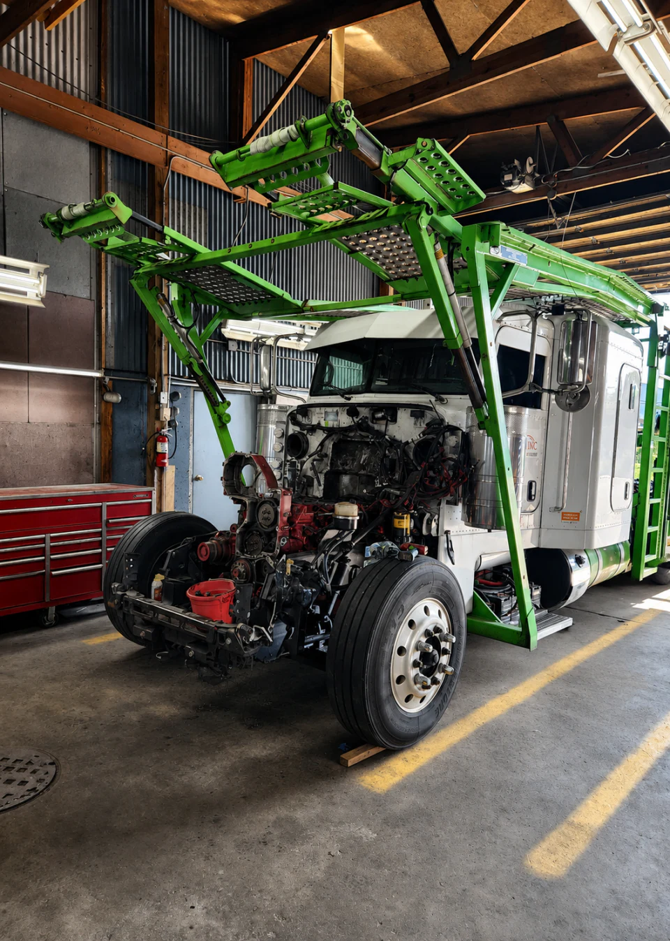 Heavy-duty truck with its engine exposed for major repair at Big Truck & Trailer Repair in Park City, Illinois